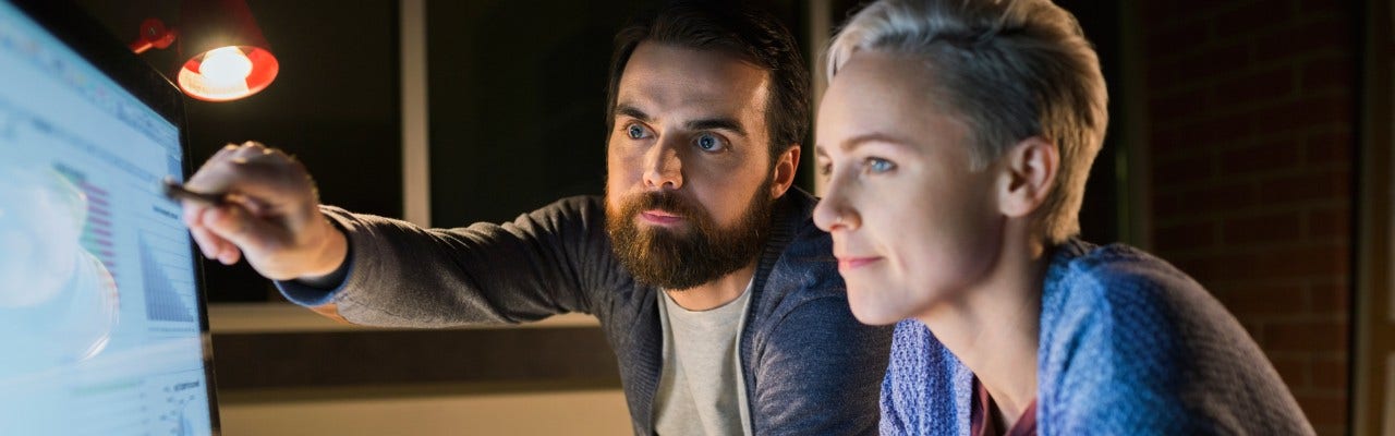 Woman and man looking at a computer screen.